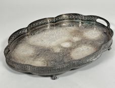 A Epns scalloped pierced gallery engraved two handled drinks tray raised on four claw and ball feet,