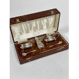 A Birmingham silver three piece  condiment set with bluster pepperette, salt seller, and mustard