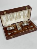 A Birmingham silver three piece  condiment set with bluster pepperette, salt seller, and mustard