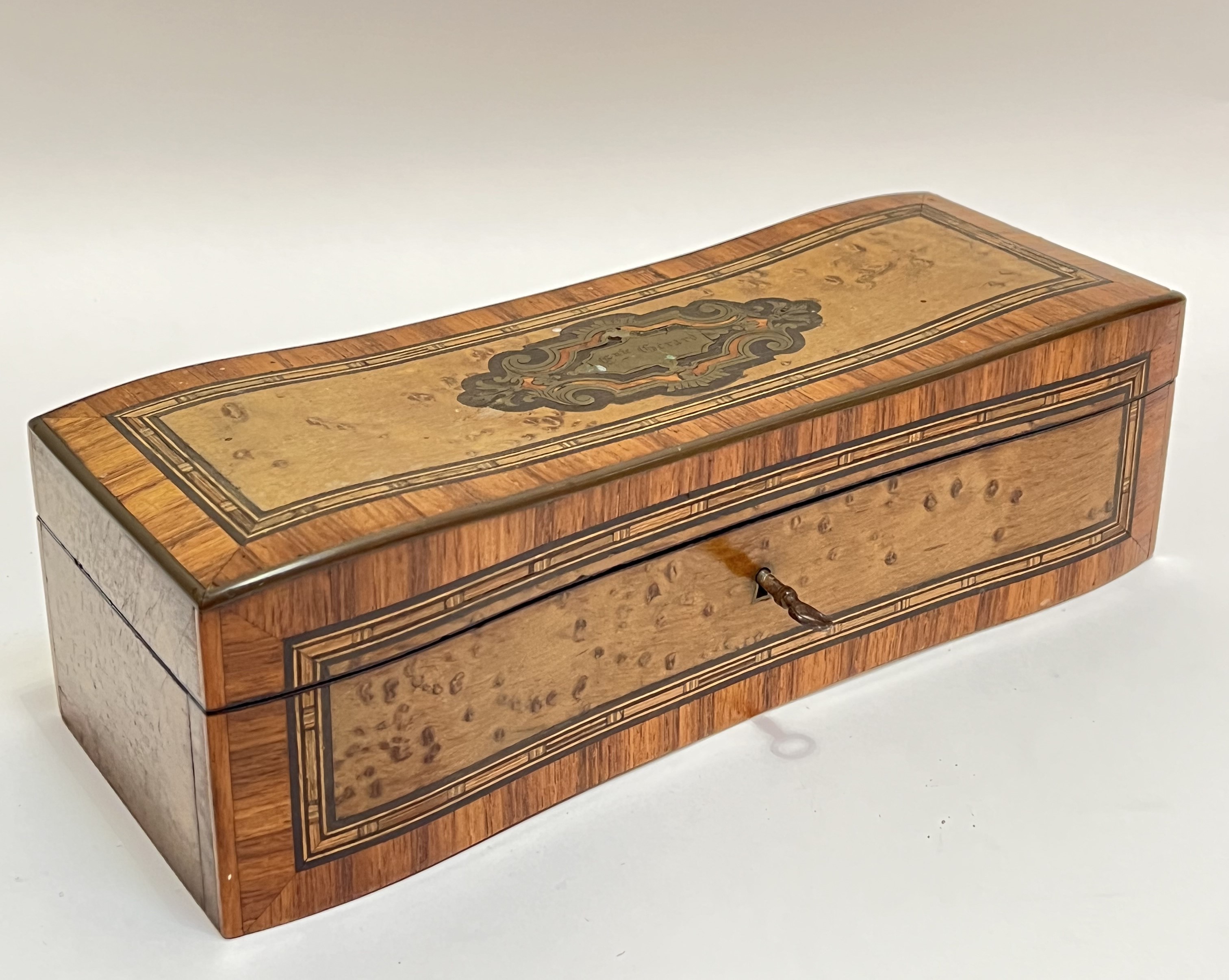 An brass-inlaid jewellery box with Rosewood crossbanding and birds eye veneer, the interior with puc