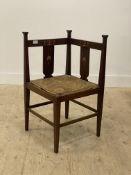 An Arts and Crafts period mahogany corner chair, the crest rail and splats with boxwood inlay