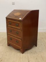 An Edwardian Sheraton revival inlaid mahogany bureau, the fall front opening to a fitted interior,