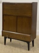A mid century tola wood (teak) bureau, the fall front opening to a fitted interior, above a