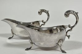 A pair of Chester silver George III style sauce boats with scalloped edges and double reversed C
