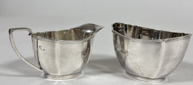A Birmingham silver two piece part tea set comprising oval panel sided sugar basin, (H x 7.5cm x L