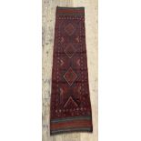 A hand knotted Meshwani runner rug, of all over lozenge design 247cm x 61cm