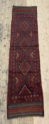 A hand knotted Meshwani runner rug, of all over lozenge design 247cm x 61cm