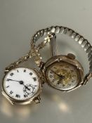 A 9ct gold vintage lady's wristwatch with white enamel dial and roman numerals on gilt metal