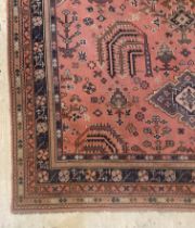 A large antique hand knotted Turkey carpet, the red ground with open floral motifs within a