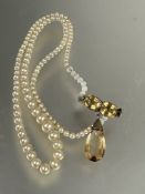 A paste pearl graduated necklace, with yellow metal twin oval foiled citrines with tear drop