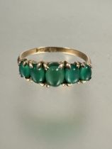 A 9ct gold five stone graduated emerald ring, each oval cabochon set in four claw setting, S. 2.3g