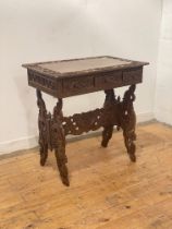 An early 20th century Chinese carved hardwood travelling writing desk, the top carved in low