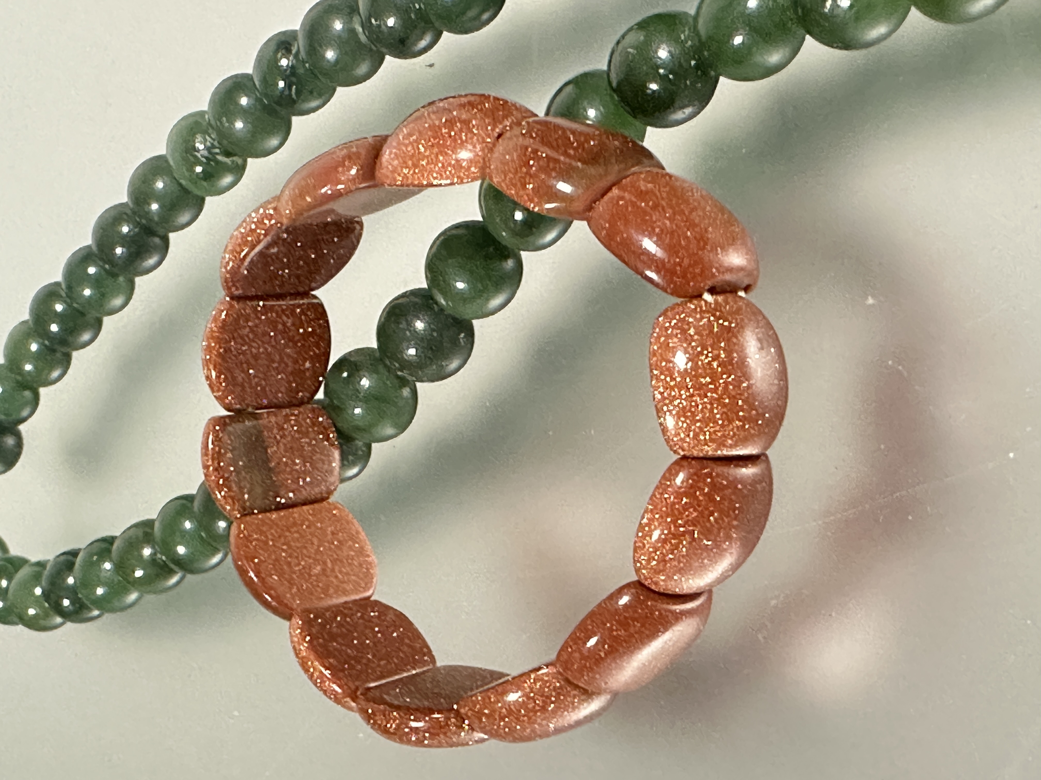 A dark green nephrite jade bead necklace with white metall barrel clasp fastening, (L X 27cm x D x