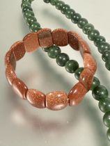 A dark green nephrite jade bead necklace with white metall barrel clasp fastening, (L X 27cm x D x