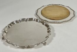 A Epns scalloped George III style drinks tray raised in three scroll feet, (H x 4cm x D x 29cm)