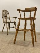A 20th century beech Windsor high chair, with hoop and spindle back, raised on turned supports (
