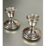A pair of modern Birmingham silver desk style tapered candle sticks on circular weighted stepped