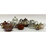 A group of miniature teapots comprising three Chinese Yixing redware teapots (two with enamelled dec
