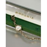 A Rodania Lady's 9ct gold manual wind wristwatch with silvered dial and Arabic numerals at the