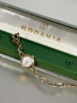 A Rodania Lady's 9ct gold manual wind wristwatch with silvered dial and Arabic numerals at the