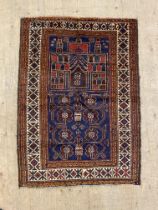 A hand knotted baluchi rug, the blue ground of floral and architectural design within a guarded