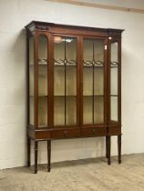 An Edwardian mahogany display cabinet, the frieze with applied carved torch motif above two