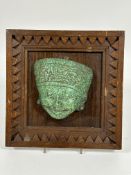 A Inca mosaic green stone moulded mask mounted in a oak frame. ( mask H x 13cm x L 13cm)