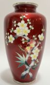 An Ando cloisonné akasuke vase with cherry blossom design outlined in silver wire over a red