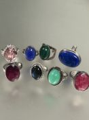 A collection of seven silver dress rings set blue stone, malachite, green stone, lapis lazuli,