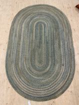 A contemporary oval flatweave herringbone wool rug 242cm x 145cm