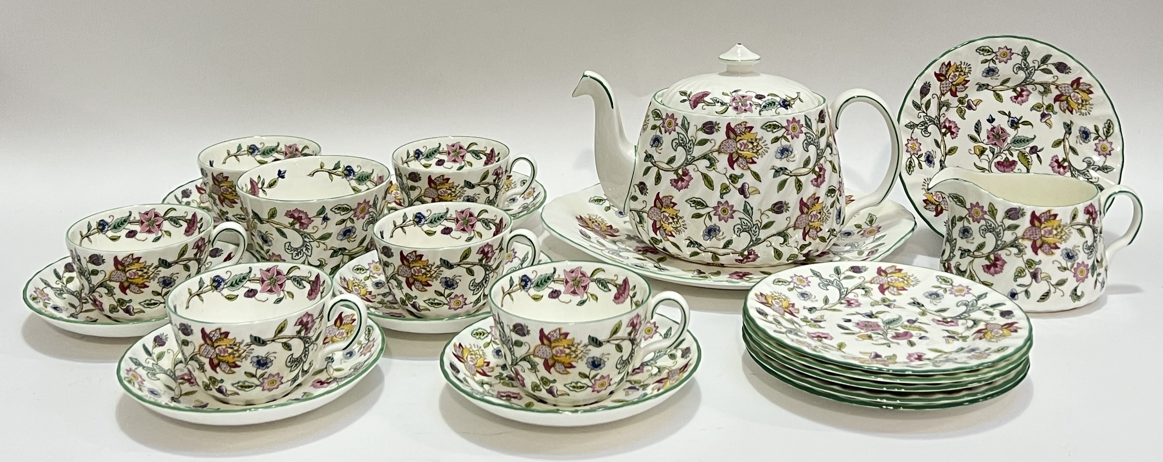 A Minton 'Haddon Hall' tea service decorated with bright floral sprays, comprising a teapot (h- 16cm