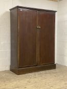 An early 20th century mahogany compactum wardrobe, the twin doors opening to reveal an interior