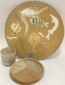 A studio pottery footed platter with slipware design of marine fish (w- 35cm), together with a small