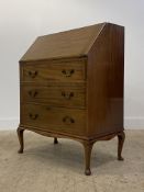 A 1930's mahogany bureau, the fall front opening to a fitted interior, above three drawers raised on