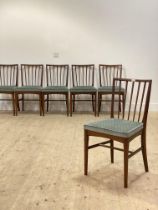 A Younger Ltd, a set of six mid century teak dining chairs with upholstered seats, raised on tapered