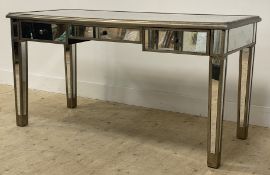 A contemporary mirrored glass and silver painted wood console table or knee hole desk, fitted with