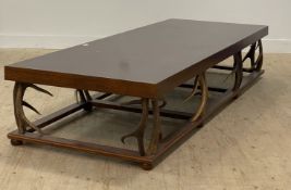 Clockhouse, a large mahogany and oak coffee table, the rectangular top raised on antler supports