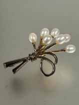 Property of the late Countess Haig: A gilt metal spray brooch set seven oval cultured pearls and a