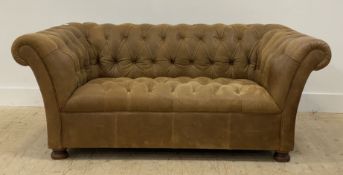 A John Lewis Chesterfield sofa, upholstered in deep buttoned suede leather, raised on turned