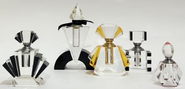 A group of Art Deco style glass perfume bottled variously coloured in red/black and yellow (largest