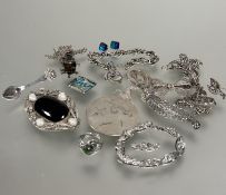 A collection of white metal and silver jewelry including circular pierced brooch, a oval filigree