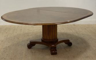 A French Napoleon III style walnut extending dining table, the cross banded circular top raised on a