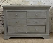 A Traditional hardwood chest of six short drawers, with panelled sides and raised on bracket
