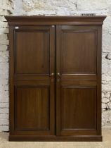 A large late 20th century stained pine and mahogany cupboard, the projecting cornice above two