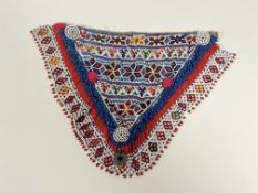 A South American beadwork V shaped chest panel with stylized flower heads, v and inverted v panels