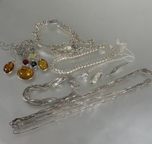 A collection of silver jewelry including two bracelets, a identity bracelet, two McIntosh style