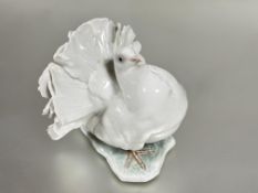 A German Rosenthal porcelain fantail dove raised on naturalistic base decorated with poly chrome