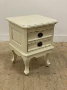 A French style cream painted two drawer bedside chest standing on cabriole supports. H66cm, W51cm,