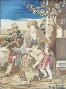 A 20thc needlepoint tapestry of a peasant mother and child stroking a cat in a wooden glazed