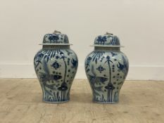 A pair of Chinese blue and white porcelain baluster vase and covers, each decorated with yuan motifs
